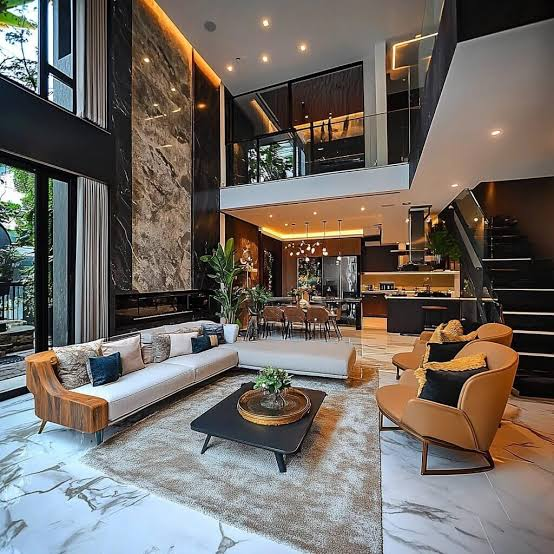 “Modern luxury living room with marble flooring, contemporary furniture, large windows, warm lighting, and an open-plan kitchen.”