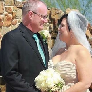 Kris Benson and Vickie Guerrero posing together on their wedding day.